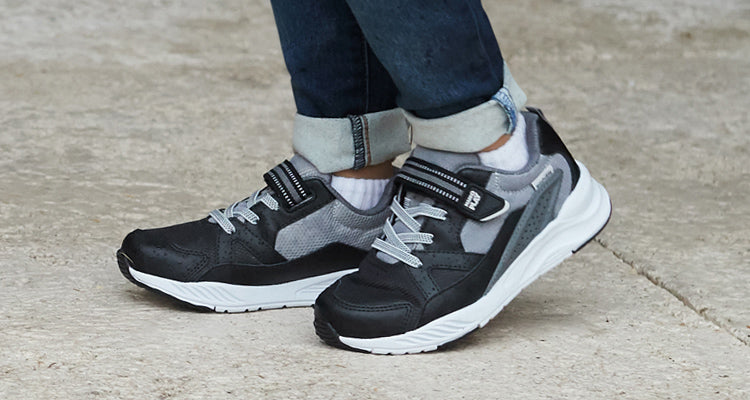 Black and grey Stride Rite sneakers.